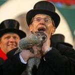 Punxsutawney Phil was held by Ron Ploucha after emerging from his burrow on Gobblers Knob in Punxsutawney, Pa., on Sunday morning.